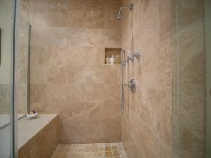 a bathroom with a shower with a glass door at Oceanviews, Fresh Upgrades At The Luxurious Grand Seascape K407!! in Wailea +32 photos