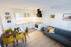 a living room with a couch and a table at Apartment Tom near Kolpa River in Metlika
