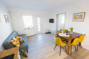 a living room with a table and a couch at Apartment Tom near Kolpa River in Metlika
