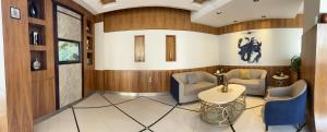 a lobby with wood paneling and a table and chairs at ديباج للشقق المخدومة in Dammam