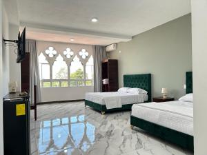 a bedroom with two beds and a window at Hotel Palace in La Concordia +160 photos