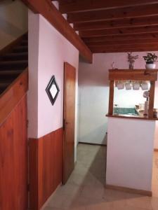 a kitchen with a counter and a staircase in a room at KEOPS Departamentos in Belén de Escobar