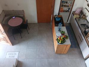 an overhead view of a kitchen with a table with fruit on it at Hostel Marilete in Três Coroas +2 photos