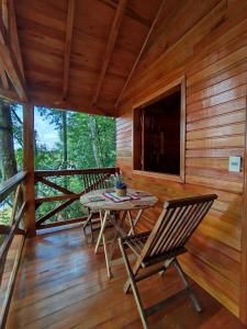a patio with a table and chairs on a deck at Chalet del lago Don Asterio in Ciudad del Este