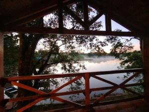 a view of a lake from a window at Chalet del lago Don Asterio in Ciudad del Este