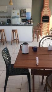 a wooden table with a tea kettle on top of it at casa Hamburgo in Búzios