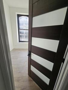 a wooden door in a room with a window at The Winston on Market in Louisville