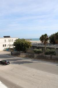 a car driving down a street next to a beach at Vigata Sea in Porto Empedocle