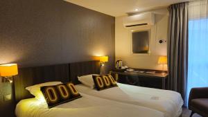 Voodi või voodid majutusasutuse Best Western Hotel Acadie Paris Nord Villepinte toas