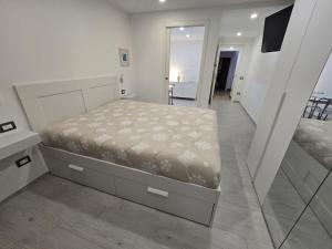a small bedroom with a bed and a mirror at Suite nel centro storico di Cagliari in Cagliari
