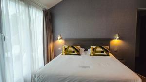 Voodi või voodid majutusasutuse Best Western Hotel Acadie Paris Nord Villepinte toas