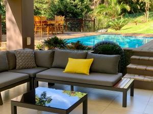 a living room with a couch and a pool at Tranquillity within the forest in Southbroom