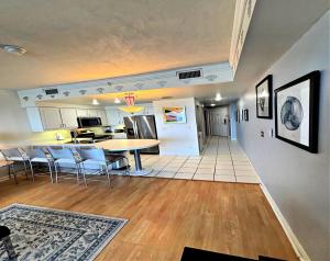 a kitchen and living room with a table and chairs at Vacation in Comfort and luxury - 1 BR Direct Oceanfront Wyndham Ocean Walk 1505 in Daytona Beach