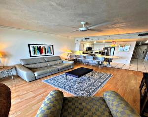 a living room with a couch and a table at Vacation in Comfort and luxury - 1 BR Direct Oceanfront Wyndham Ocean Walk 1505 in Daytona Beach +35 photos