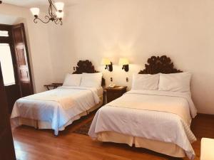 Postel nebo postele na pokoji v ubytování HOTEL MI SOLAR EJECUTIVO