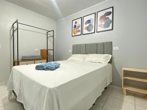 a bedroom with a large white bed in a room at Economic Central 1 Bedroom Full Kitchen in Carapicuíba