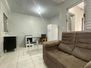 a living room with a couch and a table at Economic Central 1 Bedroom Full Kitchen in Carapicuíba