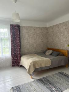 Ένα ή περισσότερα κρεβάτια σε δωμάτιο στο Jõevaara Veskitalu