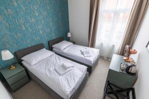 Tempat tidur dalam kamar di Kafka Prague rooms
