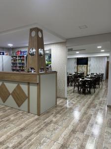 a dining room with tables and chairs and a counter at Hotel Royal Jaraguá in Jaraguá do Sul