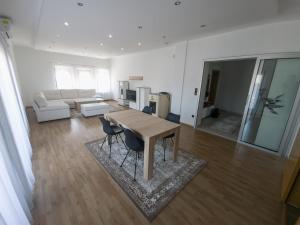 a living room with a wooden table and chairs at Milky Way in Bihać