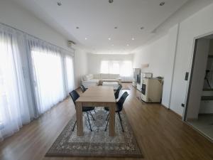 a dining room with a table and chairs in a room at Milky Way in Bihać