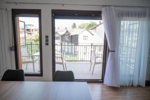 a dining room with a table and a large window at Milky Way in Bihać