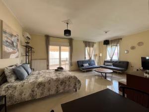 a bedroom with a bed and a living room at King George in Korinos