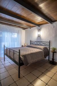 a bedroom with a bed with a wooden ceiling at Nostalgia Suites in Faliraki