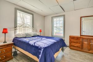 ein Schlafzimmer mit einem Bett, einer Kommode und zwei Fenstern in der Unterkunft Pet-Friendly Home with Grill and Porch in Martinsville in Martinsville
