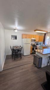 a kitchen and dining room with a table and a refrigerator at Cozy Mountain Guest house in Pine Valley