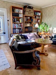 a living room with a couch and a table at Norrgården Hälsingland in Vallsta
