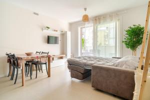 a bedroom with a bed and a table and a dining room at New bamboo holiday home Bergamo airport trade fair in Bergamo
