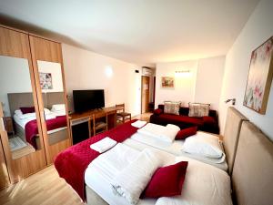 a hotel room with a large bed and a television at Garni Hotel Keltika in Izola