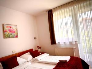 a bedroom with a bed and a window at Garni Hotel Keltika in Izola