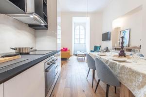 a kitchen with a long table in a room at AM6 - Dimora del Borgo in Perugia +11 photos