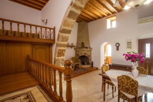 a living room with a table and a fireplace at Socrates traditional house in Haraki