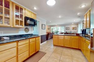 a large kitchen with wooden cabinets and counters at Casa Esmeralda in Lakewood