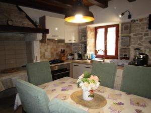 a kitchen with a table with a vase of flowers on it at Villa Sartori in Sarići