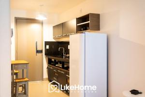 a kitchen with a refrigerator in a room at Vivir Maria Paula - Intermares in Cabedelo