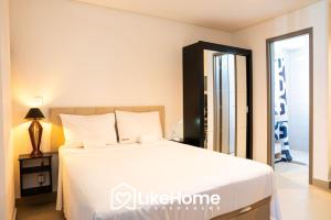 a bedroom with a white bed and a glass door at Vivir Maria Paula - Intermares in Cabedelo +13 photos