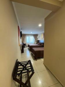a bedroom with a bed and a stool in a room at Hotel Aire de Patagonia in Río Gallegos