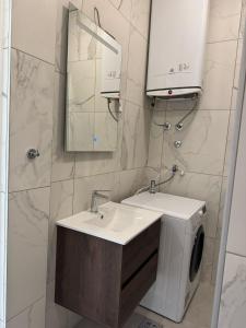 a bathroom with a sink and a washing machine at Midpoint Sea and Sun in Kotor +58 photos