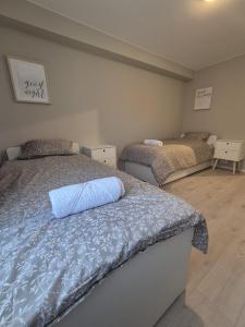 a bedroom with two beds in a room at Vakker leilighet i Åros in Søgne +33 photos