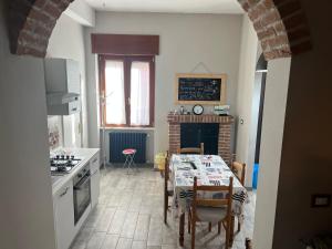 a kitchen with a table and chairs and a dining room at Festula Apartment in Genzano di Lucania