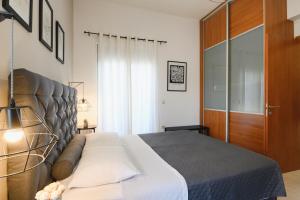 a bedroom with a bed and a wooden door at Marilena Mare Seaside & Jacuzzi House 50meters from sea in Ialysos