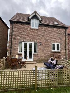 a brick house with a wooden fence in front of it at Murray's Lodge in Filey