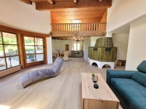 a living room with a blue couch and a table at das.arnolds | Whirlpool | Pool | Bergblick in Berchtesgaden
