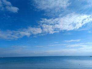 a view of the ocean with a blue sky and clouds at The SPiTi Project 32 in Kavála
