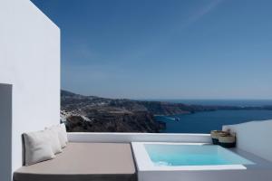 a white room with a view of the water at Cilon Suites Santorini in Imerovigli